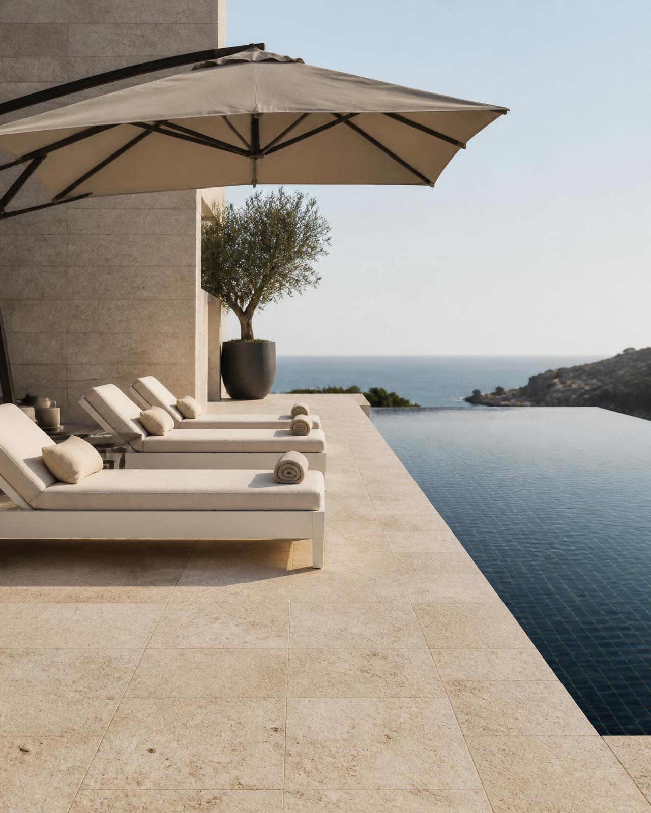 Luxury poolside with white sun lounges and a stone-toned cantilever umbrella