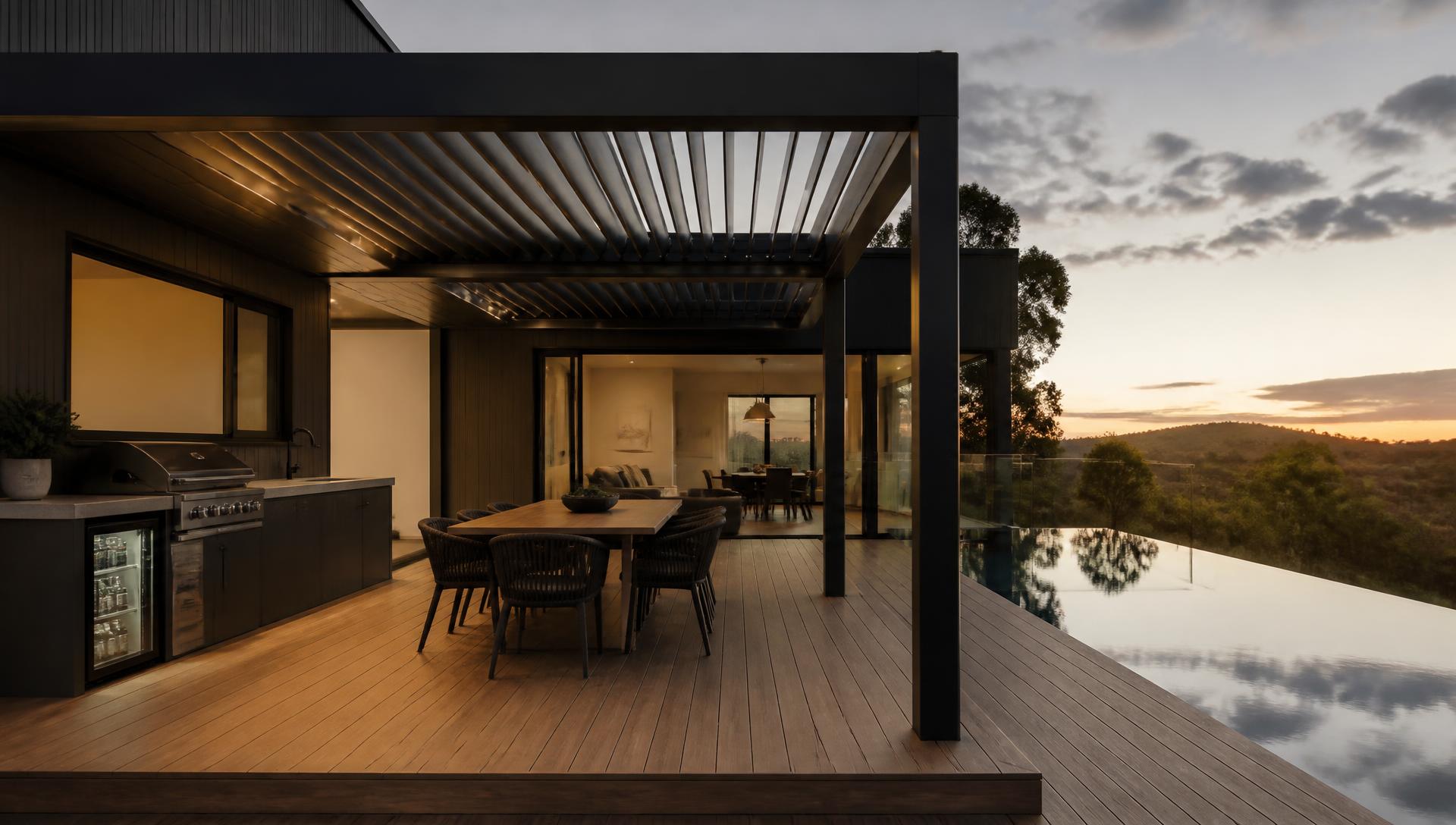 Luxury Australian outdoor entertaining area with louvred pergola, outdoor kitchen and pool at dusk
